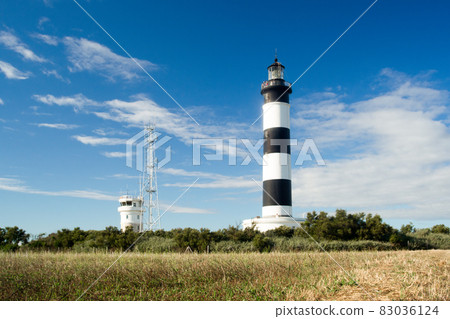 Lighthouse with blue sky and summer clouds in chassiron, Oleron Island, France Lighthouse with blue sky and summer clouds in chassiron, Oleron Island, France 83036124