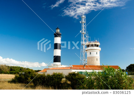 Lighthouse with blue sky and summer clouds and terracotta roof top in chassiron, Oleron Island, France Lighthouse with blue sky and summer clouds and terracotta roof top in chassiron, Oleron Island, France 83036125