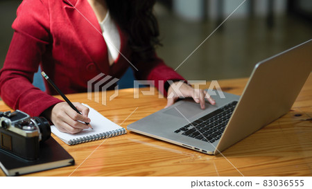 Cropped image of Professional intelligent businesswoman working on laptop Cropped image of Professional intelligent businesswoman working on laptop 83036555