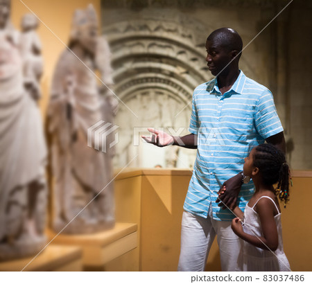 Father and daughter looking at exhibits 83037486