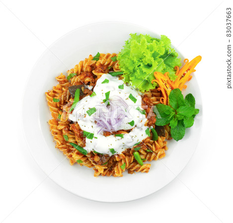 Pasta Bolognese Lentil Curry Sauce ontop Yogurt Sauce and leaf mint Pasta Bolognese Lentil Curry Sauce ontop Yogurt Sauce and leaf mint 83037663