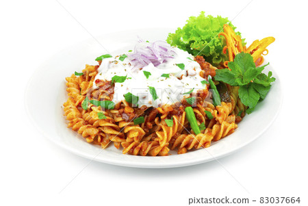 Pasta Bolognese Lentil Curry Sauce ontop Yogurt Sauce and leaf mint Pasta Bolognese Lentil Curry Sauce ontop Yogurt Sauce and leaf mint 83037664