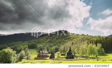 Borgund, Norway. Famous Landmark Stavkirke An Old Wooden Triple Nave Stave Church In Summer Day. Bright Summer Sun Shines Over The Ancient Old Wooden Worship. Norwegian Countryside Landscape 83039907