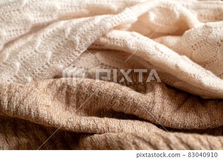 Crumpled beige wool fabric with a knitted pattern Crumpled beige wool fabric with a knitted pattern 83040910