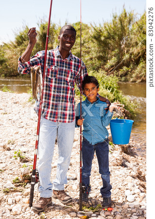 Man and boy with bucket of catch 83042276