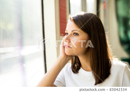 Bored unhappy woman sitting in tram 83042334