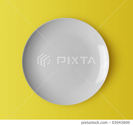 white ceramic plate on yellow 83043600