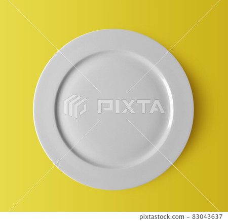 white ceramic plate on yellow 83043637