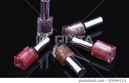 Nail polish bottles on black background Nail polish bottles on black background 83044113