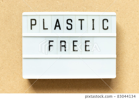Lightbox with word plastic free on wood background 83044134
