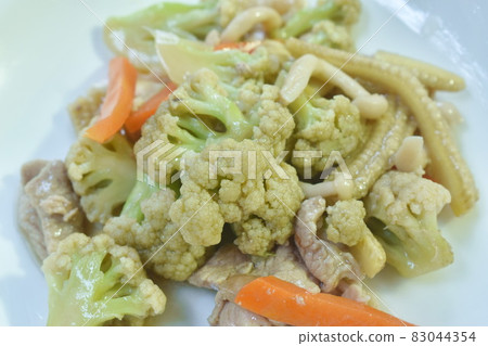 spicy stir fried cauliflower with carrot and pork on plate spicy stir fried cauliflower with carrot and pork on plate 83044354