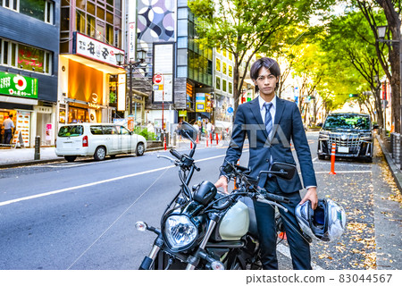 Young businessman and large motorcycle Shibuya Young businessman and large motorcycle Shibuya 83044567