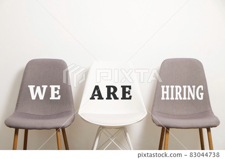 Head hunting help wanted poster concept. Minimalistic composition with chair and blank copy space wall. Head hunting help wanted poster concept. Minimalistic composition with chair and blank copy space wall. 83044738