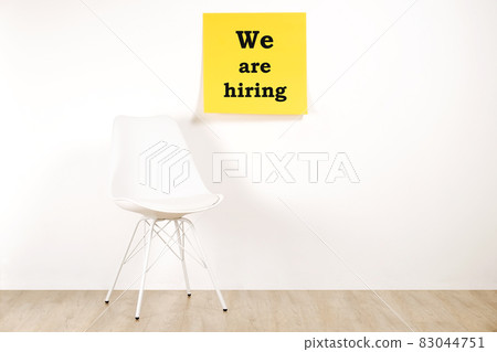 Head hunting help wanted poster concept. Minimalistic composition with chair and blank copy space wall. Head hunting help wanted poster concept. Minimalistic composition with chair and blank copy space wall. 83044751
