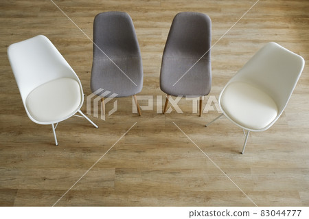 Empty chairs. Vacant job position concept. Minimlistic interior lofty room with elegant furniture pieces. 83044777