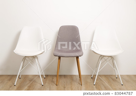 Empty chairs. Vacant job position concept. Minimlistic interior lofty room with elegant furniture pieces. 83044787