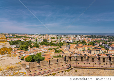 Panoramic View of medieval citadel Carcassonne from the castle walls of Carcassonne town. Ancient historical monuments of Europe on the South of France. Panoramic View of medieval citadel Carcassonne from the castle walls of Carcassonne town. Ancient historical monuments of Europe on the South of France. 83044855