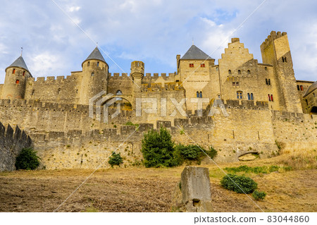 The Ancient Fortress of Carcassonne in the light of the setting sun. French Castle The Ancient Fortress of Carcassonne in the light of the setting sun. French Castle 83044860