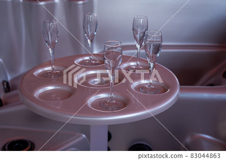 Pink table in the water tube bath. Soft focus background. Close-up 83044863