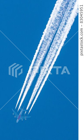 Four engined airplane during flight in high altitude with condensation trails Four engined airplane during flight in high altitude with condensation trails 83045951