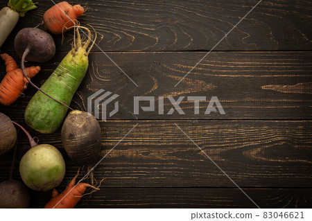 Root vegetables on a wooden background Root vegetables on a wooden background 83046621