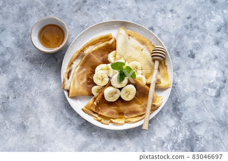 Breakfast with freshly baked cepes or thin pancakes, served with honey and cup of tea. Breakfast with freshly baked cepes or thin pancakes, served with honey and cup of tea. 83046697