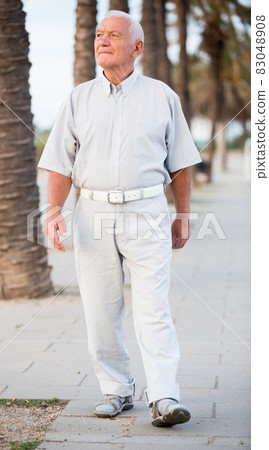 male in shirt going at the street 83048908