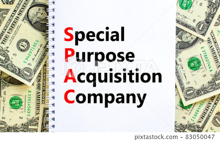SPAC, special purpose acquisition company symbol. Words SPAC, special purpose acquisition company on white note on beautiful background from dollar bills. Business and SPAC vs IPO concept. Copy space. 83050047