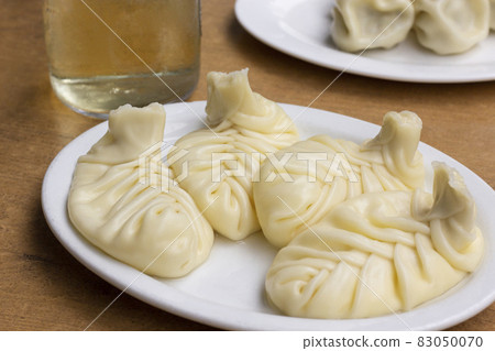 Traditional Georgian cuisine symbol. Georgian traditional Khinkali with cheese on white plate. Traditional Georgian cuisine concept. Traditional Georgian cuisine symbol. Georgian traditional Khinkali with cheese on white plate. Traditional Georgian cuisine concept. 83050070