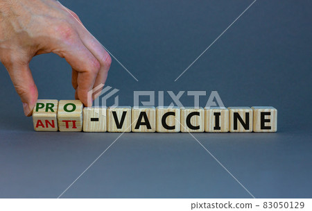 Pro-vaccine or anti-vaccine symbol. Doctor turns cubes, changes words 'anti-vaccine' to 'pro-vaccine'. Beautiful grey background. Copy space. Medical covid-19 pro-vaccine or anti-vaccine concept. Pro-vaccine or anti-vaccine symbol. Doctor turns cubes, changes words 'anti-vaccine' to 'pro-vaccine'. Beautiful grey background. Copy space. Medical covid-19 pro-vaccine or anti-vaccine concept. 83050129
