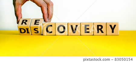 Recovery or discovery symbol. Businessman turns wooden cubes, changes a word 'discovery' to 'recovery'. Beautiful white background. Business and discovery or recovery concept. Copy space. Recovery or discovery symbol. Businessman turns wooden cubes, changes a word 'discovery' to 'recovery'. Beautiful white background. Business and discovery or recovery concept. Copy space. 83050154