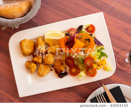 Marinated dogfish with sliced vegetables served on flat plate Marinated dogfish with sliced vegetables served on flat plate 83054134