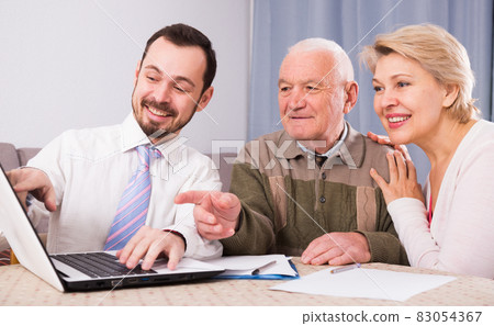 Woman and old man consider contract 83054367