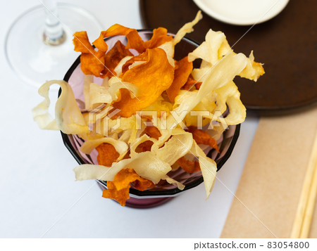 Crispy chips of sweet potatoes and cassava served with wine Crispy chips of sweet potatoes and cassava served with wine 83054800