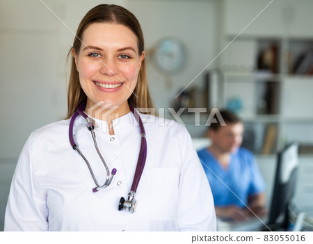 Smiling female doctor in medical office Smiling female doctor in medical office 83055016