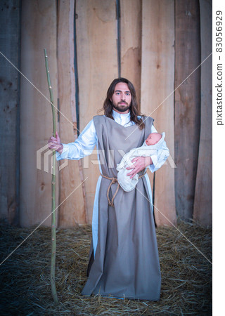 Joseph holding Jesus baby in a lgtb nativity scene Joseph holding Jesus baby in a lgtb nativity scene 83056929