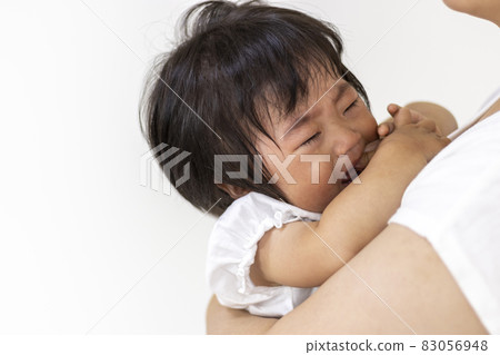 Baby crying while being held by her mother (1 year and 2 months old, Japanese, girl) Baby crying while being held by her mother (1 year and 2 months old, Japanese, girl) 83056948