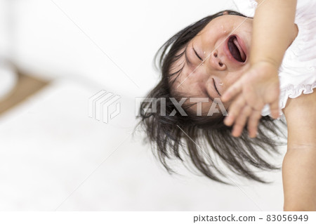 Baby crying while being held by her mother (1 year and 2 months old, Japanese, girl) 83056949