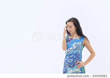 Young woman rubbing white background 83056962
