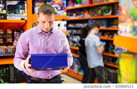 Man buying toys in store 83060521