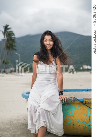 Black long curly hair. Looking at camera with copy space and smiling. Romantic photo. Mountain view. High quality photo 83062420