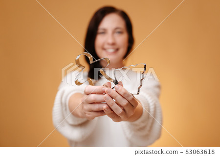Metal molds for baking cookies in blurred woman's hands. Metal molds for baking cookies in blurred woman's hands. 83063618