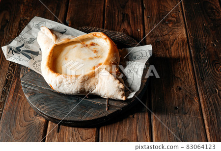 khachapuri is a traditional Georgian bread with cheese filling, egg yolk and butter. Georgian bread 83064123