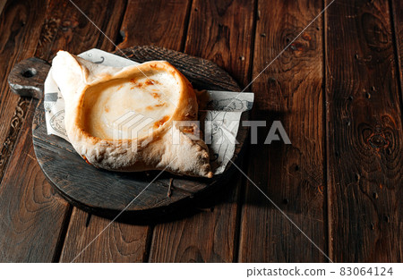 khachapuri is a traditional Georgian bread with cheese filling, egg yolk and butter. Georgian bread 83064124