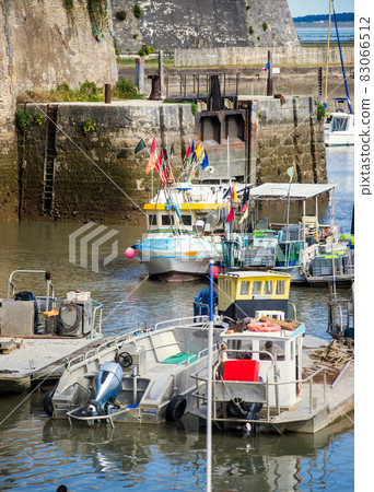 Fishing boats and oyster farmers boats at low tide in the port of Chateau d'Oleron Fishing boats and oyster farmers boats at low tide in the port of Chateau d'Oleron 83066512