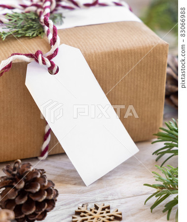 Christmas present with blank gift tag and decorations, Mockup Christmas present with blank gift tag and decorations, Mockup 83066988