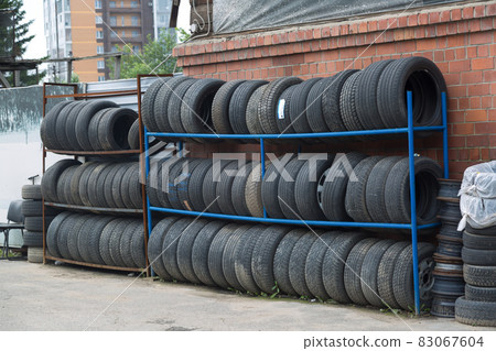 Car tires are on racks near the service station Car tires are on racks near the service station 83067604