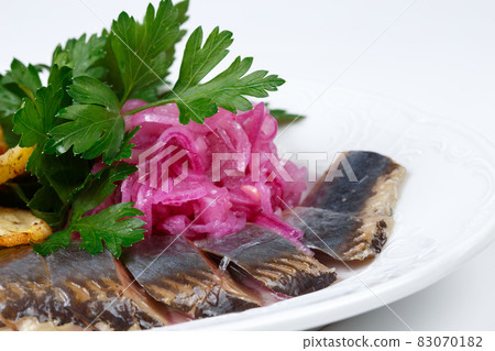 Photo of pickled herring with potato, parsley and onion 83070182