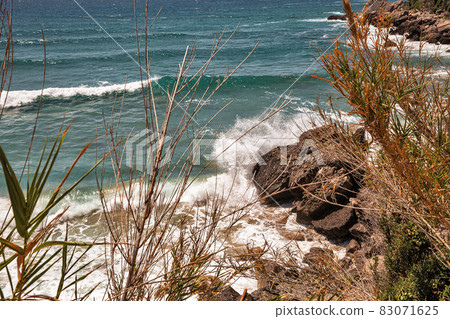 Sea waves crashing onto rocks with water splashes. Corfu island, Greece. Sea waves crashing onto rocks with water splashes. Corfu island, Greece. 83071625