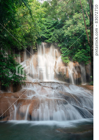 Sai Yok Noi waterfall flowing on limestone in tropical rainforest at national park 83072710